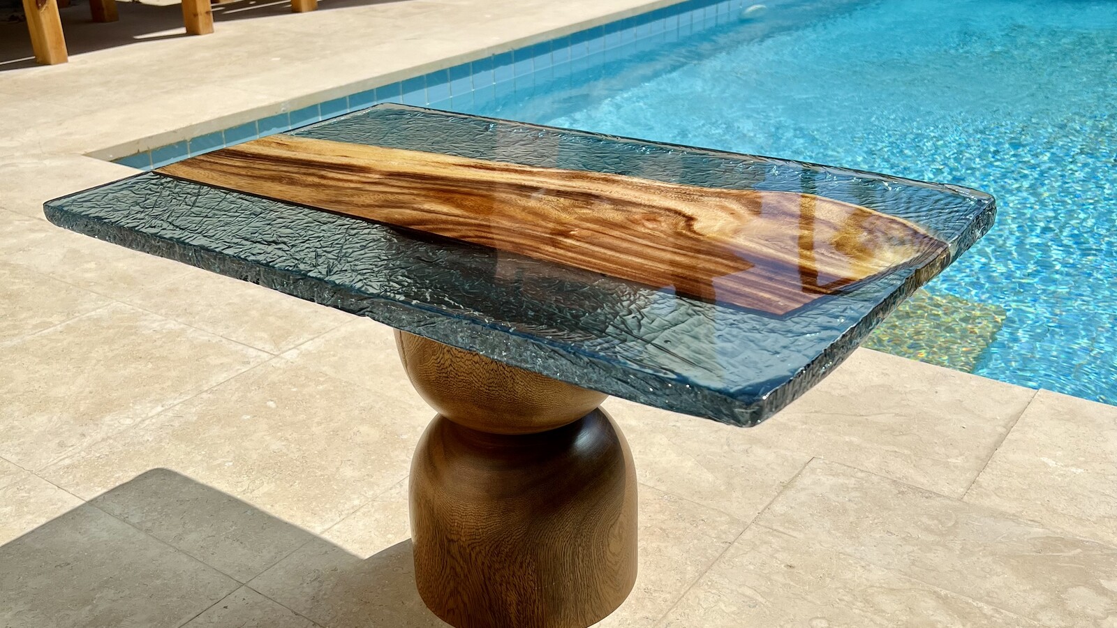 A pair of Strata tables on the Red Sea coast — live-edge wood in turquoise cast resin